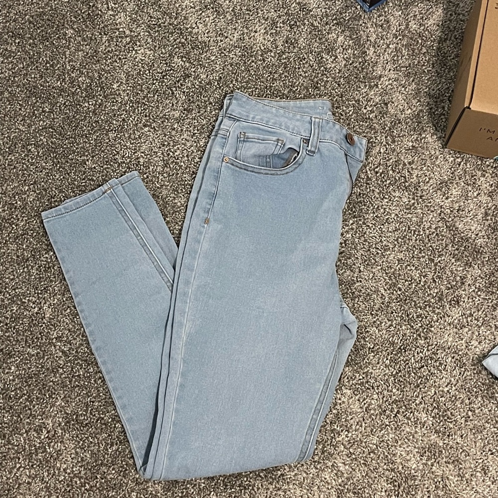 Light blue skinny jeans; no rips